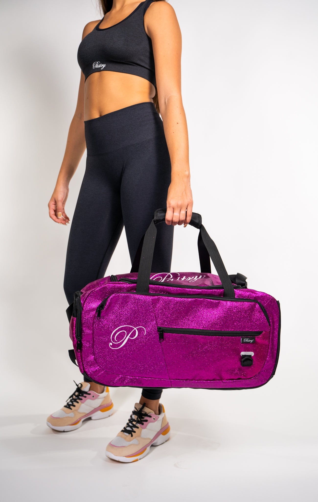 Woman carrying Pastry Duffle Bag Glitter Hot Pink